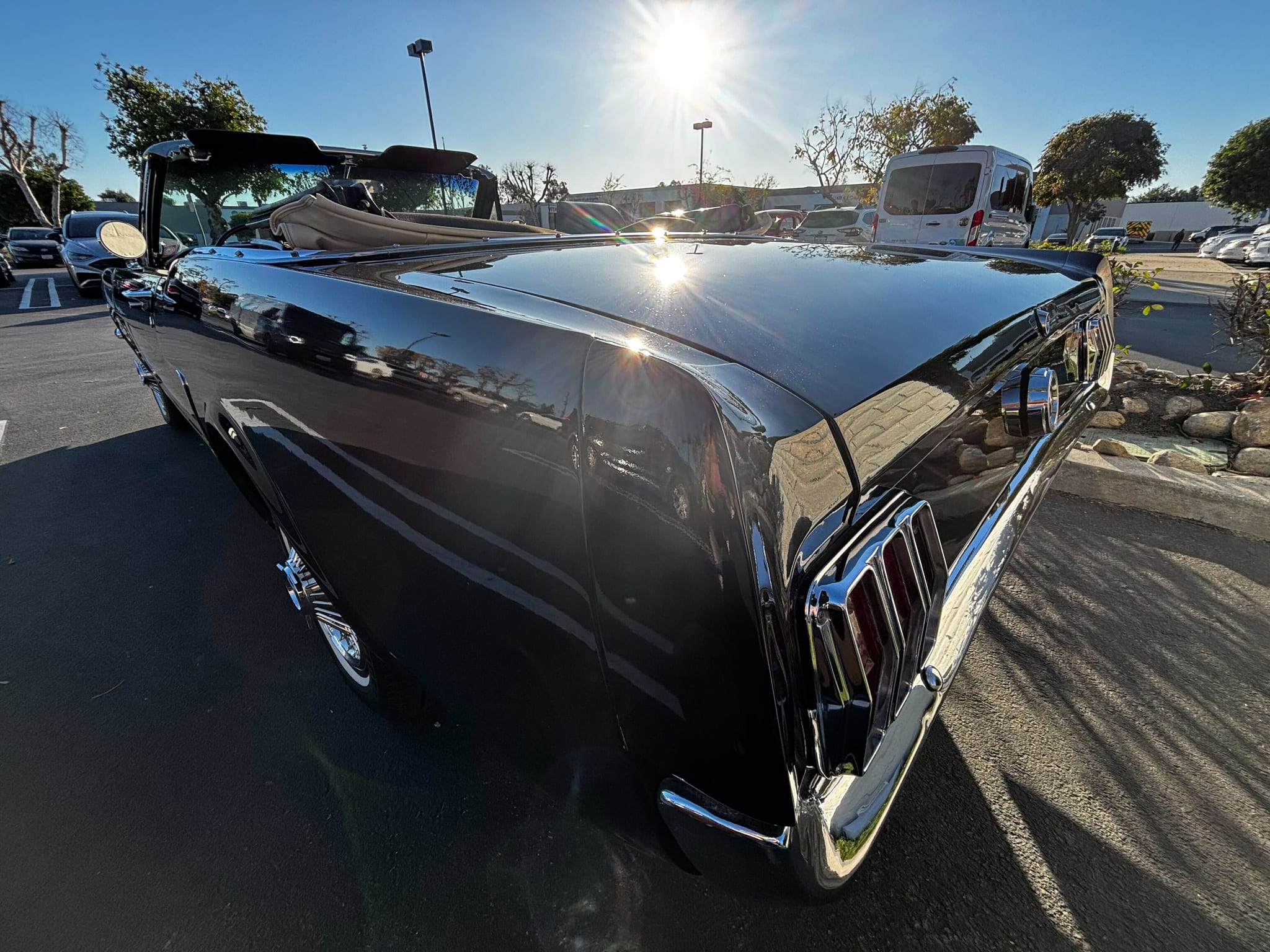 Black Ford Mustang convertible with a deep gloss finish and chrome trim