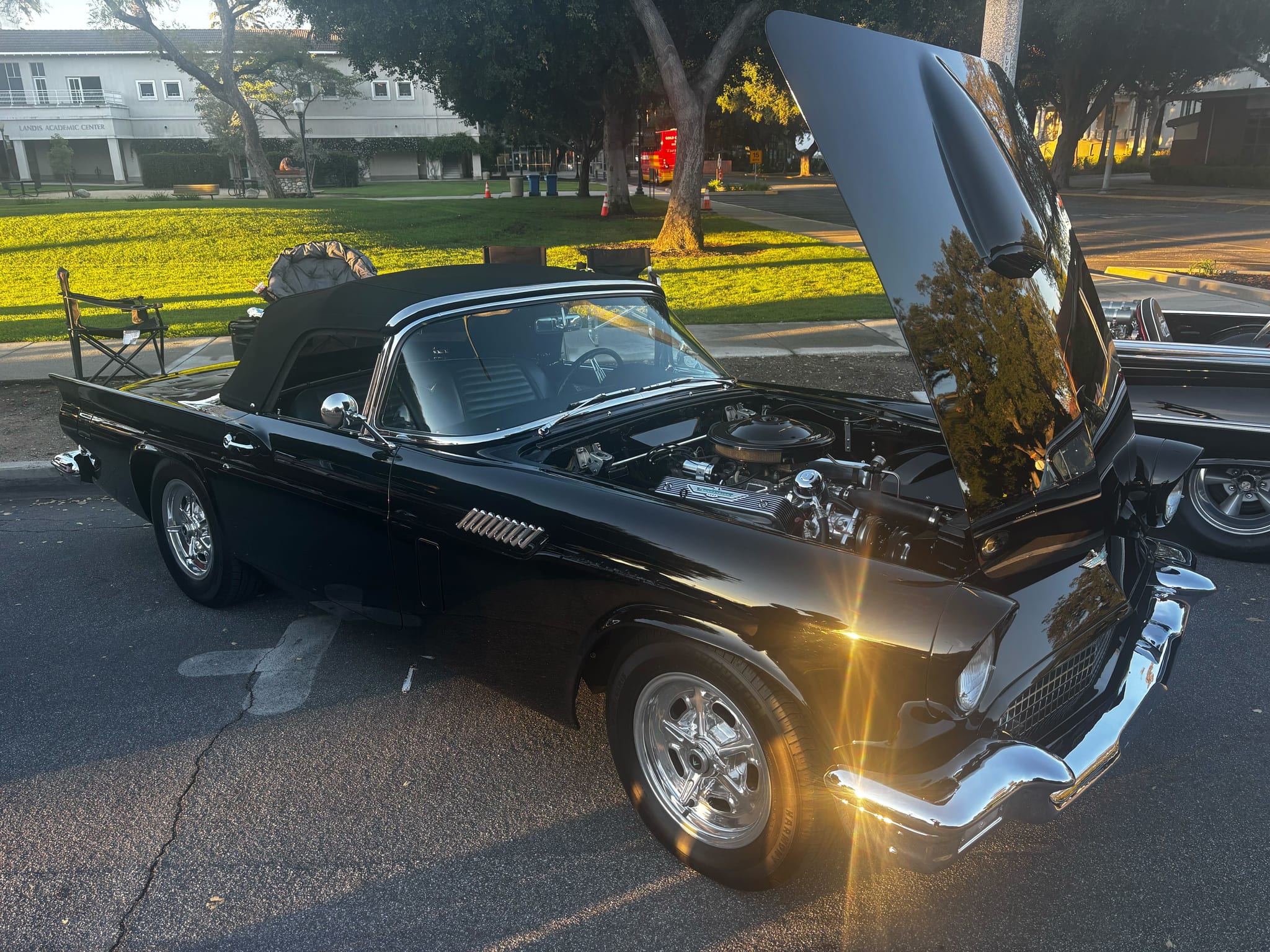 Black Ford Thunderbird with hood open, showing a polished engine bay after a full detail